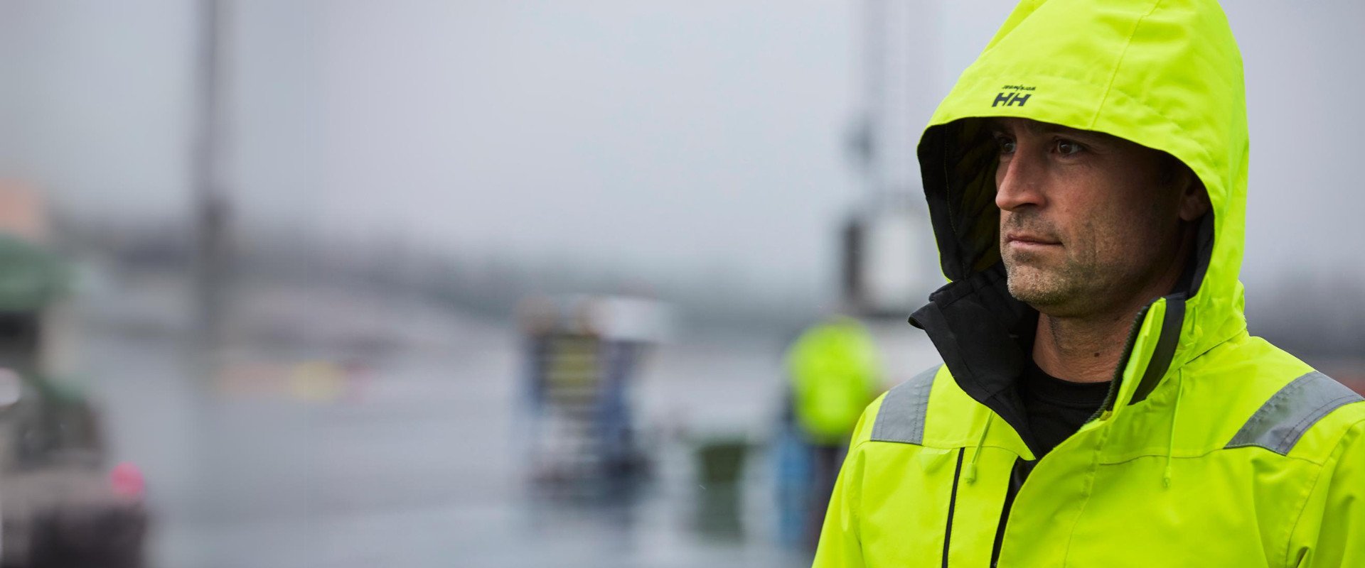 close up of a man in a hi-vis jacket with his hood up